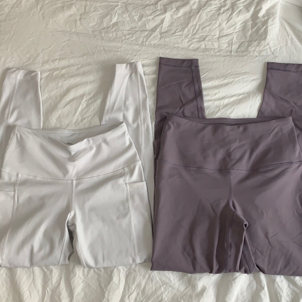 2 pairs of leggings purple/grey and white.